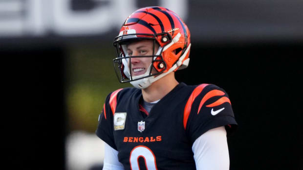 Nov 12, 2023; Cincinnati, Ohio, USA; Cincinnati Bengals quarterback Joe Burrow (9) smiles toward Houston Texans linebacker Denzel Perryman (6) on a fourth-down play in the second quarter of a Week 10 NFL football game between the Houston Texans and the Cincinnati Bengals at Paycor Stadium. Mandatory Credit: Kareem Elgazzar-USA TODAY Sports  
